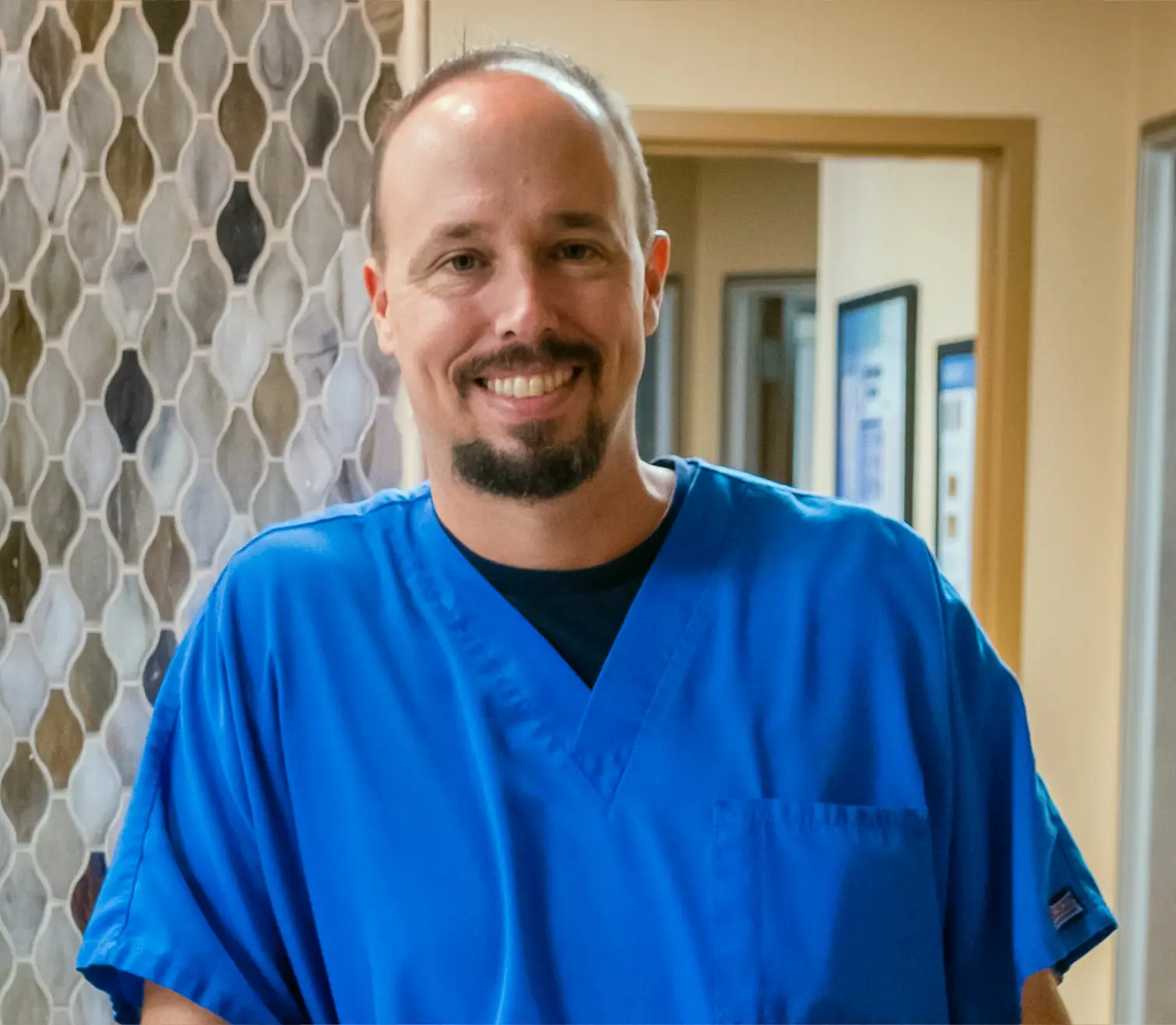 Smiling male nurse at Victoria Vein Clinic.